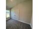 Bright bedroom with carpeted floor and double doors at 36188 Welsh Glade Rd, Dade City, FL 33525