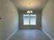 Bright dining room with tile floors and a chandelier at 36188 Welsh Glade Rd, Dade City, FL 33525
