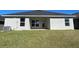 Single story home with covered patio and grassy backyard at 36188 Welsh Glade Rd, Dade City, FL 33525