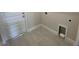 Laundry room with tile floor and built-in storage at 36188 Welsh Glade Rd, Dade City, FL 33525
