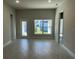 Bright living room featuring tile floors and access to backyard at 36188 Welsh Glade Rd, Dade City, FL 33525