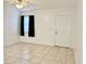 Living room with a white front door, tile floors, a window, and a ceiling fan at 7112 Waterside Dr, Tampa, FL 33617