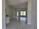 Open living room with tile flooring and large window at 36158 Welsh Glade Rd, Dade City, FL 33525