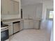 Modern kitchen with gray cabinets, granite countertops, and stainless steel appliances at 36158 Welsh Glade Rd, Dade City, FL 33525