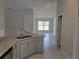 Modern kitchen with gray cabinets, granite countertops, and stainless steel appliances at 36158 Welsh Glade Rd, Dade City, FL 33525