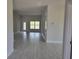 Open living room with tile flooring and large window at 36158 Welsh Glade Rd, Dade City, FL 33525