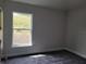 Bright bedroom featuring carpet flooring and a window view at 36158 Welsh Glade Rd, Dade City, FL 33525