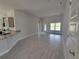 Open living room featuring tile floors and a view into the kitchen at 36158 Welsh Glade Rd, Dade City, FL 33525