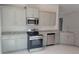 Modern kitchen with gray cabinets, granite countertops, and stainless steel appliances at 36158 Welsh Glade Rd, Dade City, FL 33525