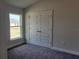 Well-lit bedroom with carpet flooring and double door closet at 36158 Welsh Glade Rd, Dade City, FL 33525