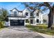 Striking two-story home with a brick driveway, dark window trim and a well-manicured lawn at 2106 S Cortez Ave, Tampa, FL 33629