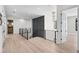 Upstairs hallway with modern railing, stylish lighting, and access to multiple rooms at 2106 S Cortez Ave, Tampa, FL 33629