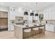 Contemporary kitchen with a large island, pendant lighting, white cabinetry, and stainless steel appliances at 2106 S Cortez Ave, Tampa, FL 33629