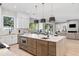 Modern kitchen featuring a large island with seating and access to the living and outdoor area at 2106 S Cortez Ave, Tampa, FL 33629