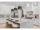 Spacious kitchen features a large island with marble countertop, seating, and stainless steel appliances at 2106 S Cortez Ave, Tampa, FL 33629