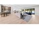Open-concept living room leading to modern kitchen and wet bar with view of the pool through sliding glass doors at 2106 S Cortez Ave, Tampa, FL 33629