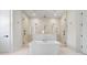 Luxurious bathroom with a free-standing tub, rainfall shower, and marble finishes at 2106 S Cortez Ave, Tampa, FL 33629
