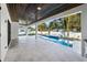 Inviting outdoor living space features a pool, spa, covered patio, and lush landscaping, perfect for relaxation at 2106 S Cortez Ave, Tampa, FL 33629