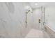 Spa-like shower featuring elegant marble tile, gold shower fixtures, and a built-in shower niche at 2106 S Cortez Ave, Tampa, FL 33629