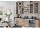Modern wet bar with glass cabinetry, sleek countertops, and a built-in wine cooler, perfect for entertaining at 2106 S Cortez Ave, Tampa, FL 33629