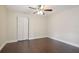 Bright bedroom with dark hardwood floors and a double door closet at 3554 Deer Run S, Palm Harbor, FL 34684