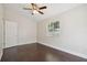 Well-lit bedroom featuring dark hardwood floors and a window at 3554 Deer Run S, Palm Harbor, FL 34684