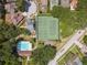 Aerial view of community tennis courts, pool, and homes at 3554 Deer Run S, Palm Harbor, FL 34684