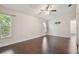 Spacious bedroom with dark hardwood floors and ceiling fan at 3554 Deer Run S, Palm Harbor, FL 34684