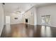 Spacious living room featuring hardwood floors and access to a private patio at 3554 Deer Run S, Palm Harbor, FL 34684