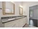 Double vanity bathroom with granite countertop and large mirrors at 3554 Deer Run S, Palm Harbor, FL 34684