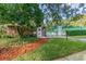 Landscaped pool area with brick building and gate at 3554 Deer Run S, Palm Harbor, FL 34684