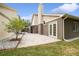 Large back patio with access to the house and a grassy area at 3554 Deer Run S, Palm Harbor, FL 34684