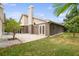 Landscaped backyard with a grassy lawn and mature trees at 3554 Deer Run S, Palm Harbor, FL 34684