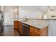 Granite countertop kitchen island with sink and dishwasher at 3554 Deer Run S, Palm Harbor, FL 34684