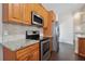 Stainless steel appliances and wood cabinets in this kitchen at 3554 Deer Run S, Palm Harbor, FL 34684