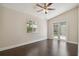 Bedroom with hardwood floors and French doors to backyard at 3554 Deer Run S, Palm Harbor, FL 34684
