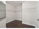 Large walk-in closet with wire shelving and dark hardwood floors at 3554 Deer Run S, Palm Harbor, FL 34684