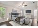 Virtually staged bedroom with large bed and ample natural light at 3554 Deer Run S, Palm Harbor, FL 34684