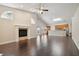 Open living room with hardwood floors, fireplace, and kitchen views at 3554 Deer Run S, Palm Harbor, FL 34684