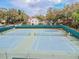 Community tennis courts with surrounding trees and fencing at 3554 Deer Run S, Palm Harbor, FL 34684
