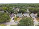 Aerial view of a residential neighborhood with houses and trees at 3554 Deer Run S, Palm Harbor, FL 34684