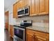 Close-up of kitchen range and microwave at 3554 Deer Run S, Palm Harbor, FL 34684