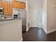 Kitchen entry with stainless steel appliances and dark hardwood floors at 3554 Deer Run S, Palm Harbor, FL 34684