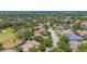 Wide aerial shot of a charming neighborhood with lush greenery and a nearby golf course at 1227 Toscano Dr, Trinity, FL 34655