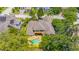 Aerial view of a home surrounded by lush trees with a pool in the backyard at 1227 Toscano Dr, Trinity, FL 34655