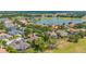 Wide aerial shot of a charming neighborhood with lush greenery, golf course, and nearby water view at 1227 Toscano Dr, Trinity, FL 34655