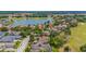 Wide aerial shot of a charming neighborhood with lush greenery, golf course, and nearby water view at 1227 Toscano Dr, Trinity, FL 34655