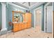 This bathroom offers a wooden vanity with granite countertop, tiled floor, and ample storage at 1227 Toscano Dr, Trinity, FL 34655