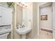 This bathroom has a pedestal sink, a large mirror, and an ornate decor for extra charm at 1227 Toscano Dr, Trinity, FL 34655