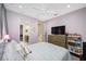 A bedroom featuring a ceiling fan, a tv, and access to the bathroom at 1227 Toscano Dr, Trinity, FL 34655